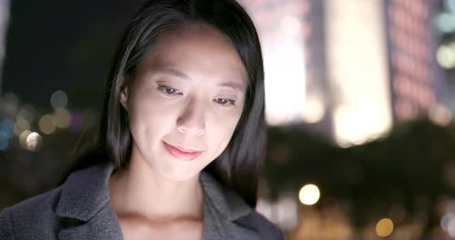 Young Adult Using Mobile Device At Night