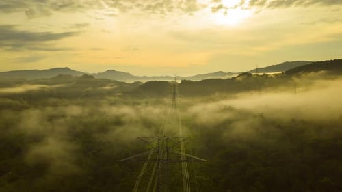 Golden Sunrise Over Misty Green Hills and Powerline