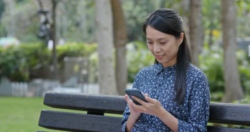 Woman use of mobile phone in park
