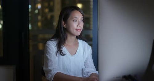 Woman work on computer at night