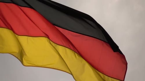 German Flag Waving Against Gray Sky