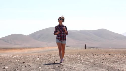 Happy woman walking in the desert in Fuerteventura