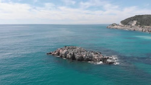 Des vagues s'écrasent contre une falaise rocheuse vide