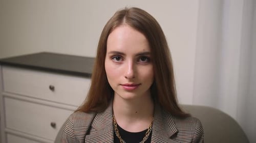 Confident Smiling Young Woman Looking at Camera Standing at Home Office