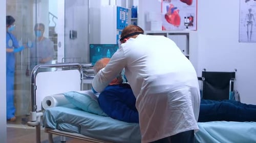 Doctor Attends Senior Patient With Oxygen Mask