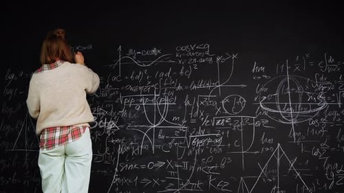 Woman Writing Complex Equations on a Chalkboard