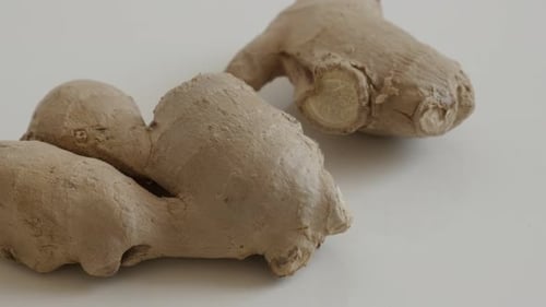Close-up of Fresh Ginger Root on White Surface