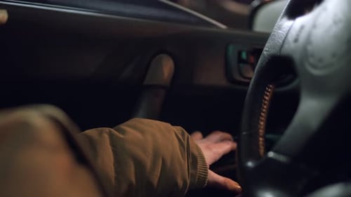 Man Hand Pressing a Button to Close the Window of a Car