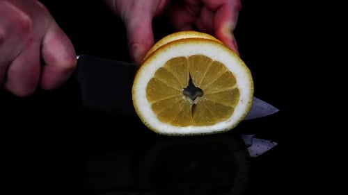 Orange Slicing with Sharp Knife Close-up