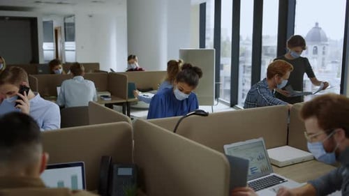 Businesswomen and Businessmen Working in Office During Coronavirus Pandemic