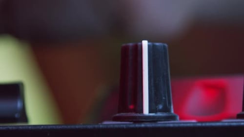 Finger Adjusting Dials on Audio Equipment