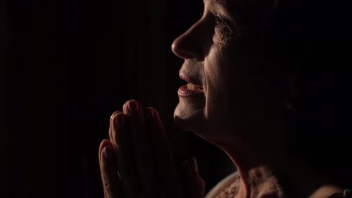 Woman Praying at Dark Room