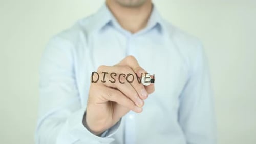 Man Writes the Word Discover with a Marker