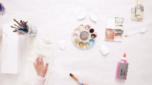 Time lapse. Mother and daughter painting with gold paint clay sculpted horn and ears for decorating