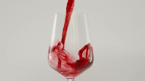 Close Up Shot of Pouring Red Wine in Glass at 1000 Fps White Background