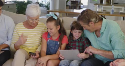 Multi-Generational Family Using Technology Together on Couch