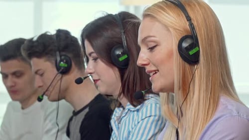Charming Female Call Center Operator Smiling To the Camera While Working
