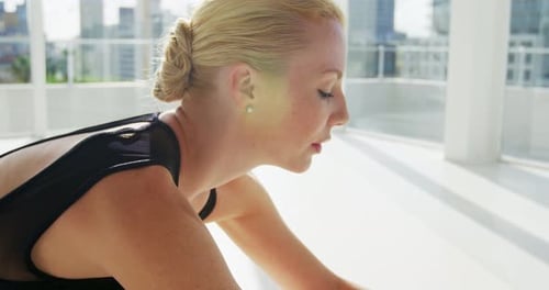 Blonde Woman Stretching Legs in Bright Studio