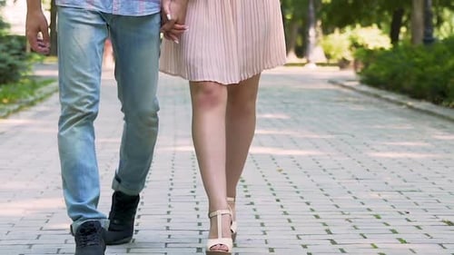 Young Man and Woman Legs Walking on Park Path, Holding Hands, Romantic Date