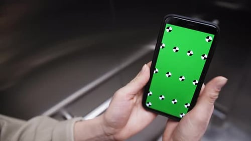 Hand Holding Phone with Green Screen Mockup