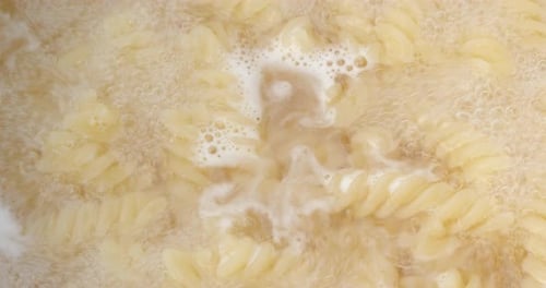 Fusilli Pasta Bubbling Vigorously in Boiling Water