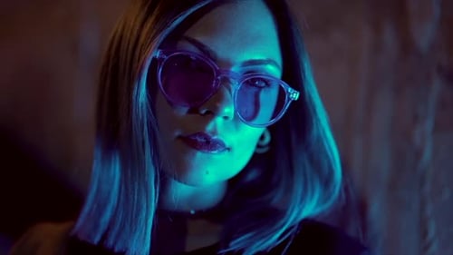 Trendy Woman with Sunglasses Posing at Night