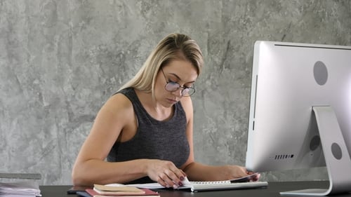 Woman Working at Computer in Modern Office