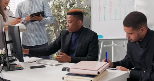 Company Employees Work Together Sit at a Computer Planning Organizing a Project a Man in a Garnish