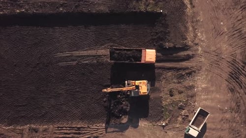 Zoom Out Top Down View of Construction Site with Machinery, Truck, Excavator.
