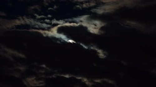 Clouds Passing over the Moon at Night