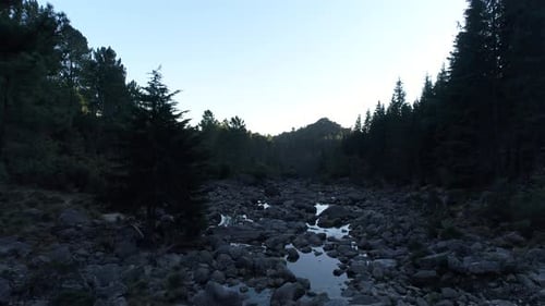 Flight along Riverbed in the Mountains