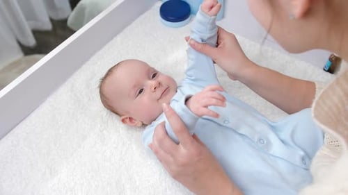 Loving Mother Bonding with Infant on Changing Table