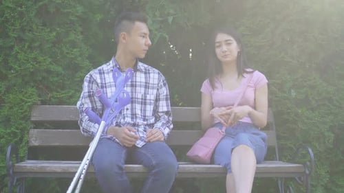Young Couple Chatting on a Park Bench