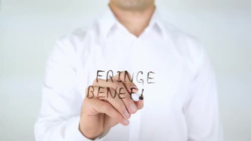 Man Writing Fringe Benefits on Clear Surface