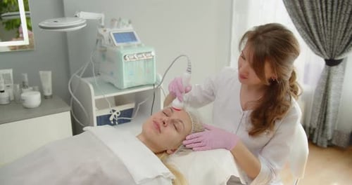 Woman Receives A Hardware Phonophoresis Procedure From A Cosmetologist In A Spa Salon
