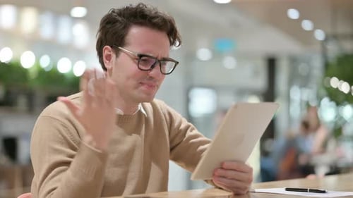 Failure for Young Male Designer on Tablet in Office