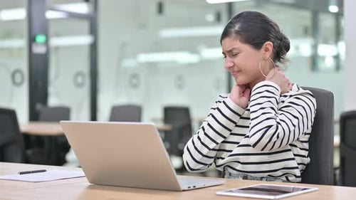 Tired Indian Woman with Laptop Having Neck Pain in Office