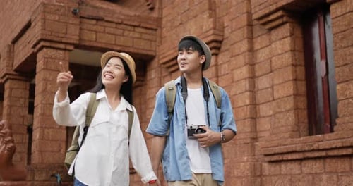 Couple hand together while visiting at ancient temple