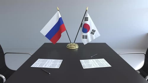 Flags of Russia and South Korea on the Table