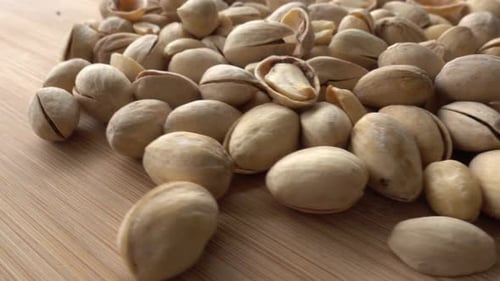 Heap of Pistachios on a Wooden Surface