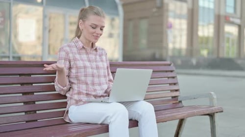 Woman on Laptop Video Call on Park Bench