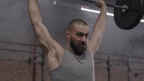 Sportsman Lifting Weights in Gym