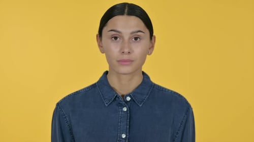 Young Woman Posing Against Yellow Background