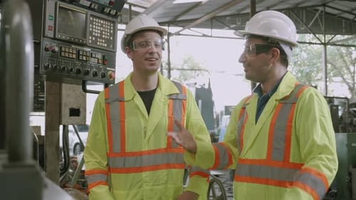 Two young engineer man maintenance checking and inspect on machine at industrial factory.