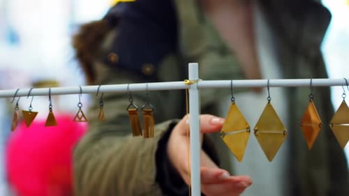 Young Woman Shopping for Earrings at a Boutique