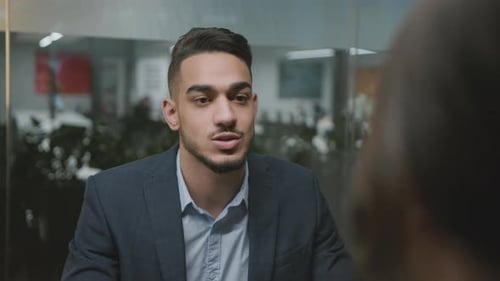 Young Adult Man Speaking in a Modern Office
