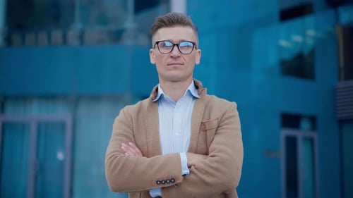 Confident Man Smiling Outside Modern Building