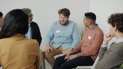 Diverse Group of People Discussing Problems During Therapy Meeting Sharing Ideas Sitting in Circle