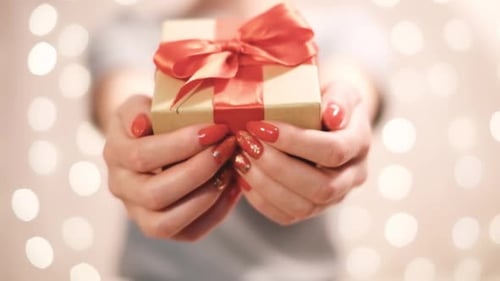 Close Up of a Present Held by Woman's Hands