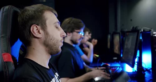 Two Gamers Puts on Headphones with a Mic On and Starts Playing Online Video Game , Close Up. , Move